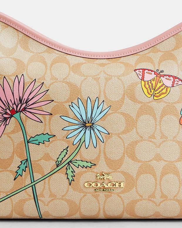 حقيبة "كوتش" (Coach) هوبو - تصميم Signature Canvas بنقشة الزهور والفراشات المميزة